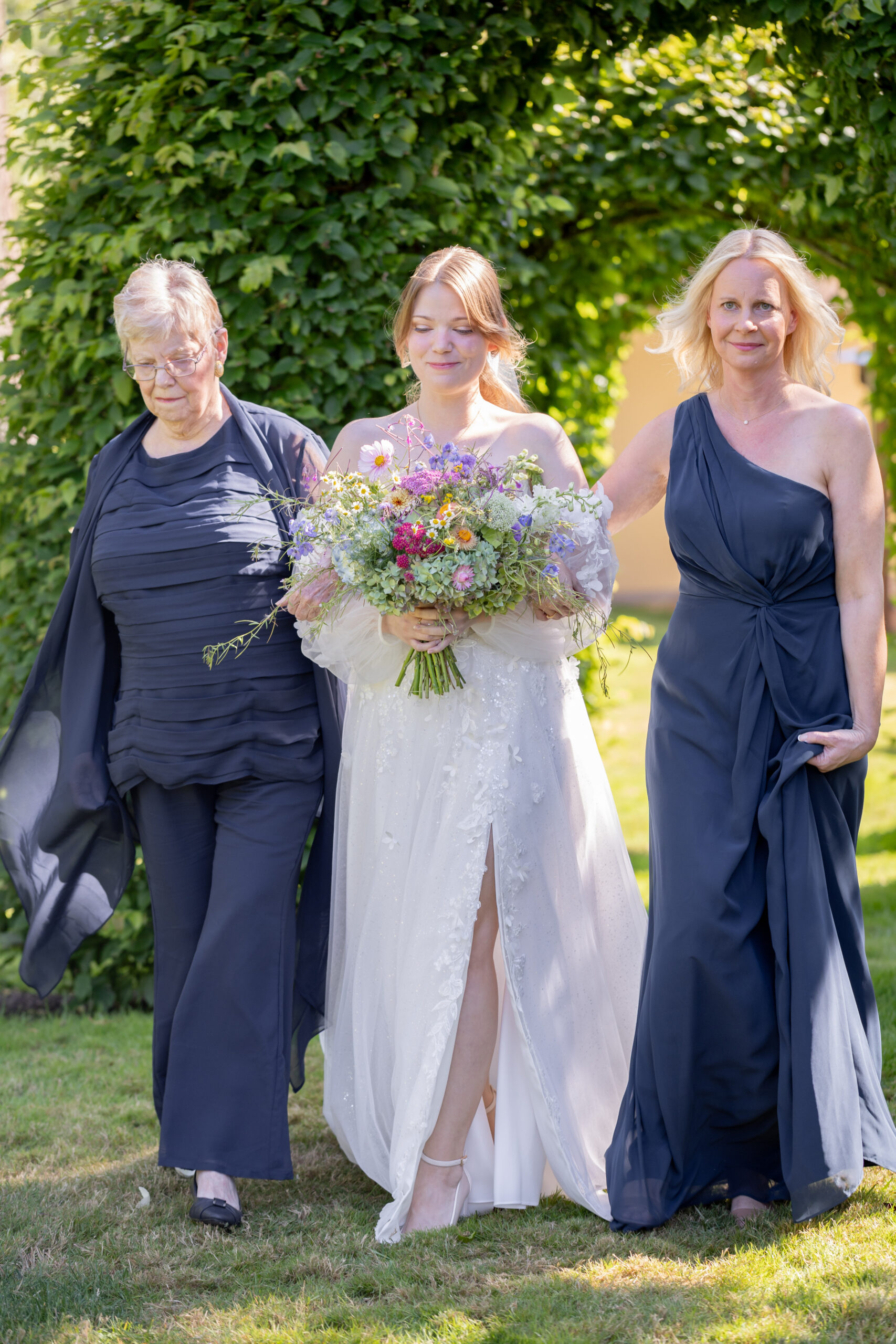 bride-walking-down-the-aisle-with-mom-and-grandma