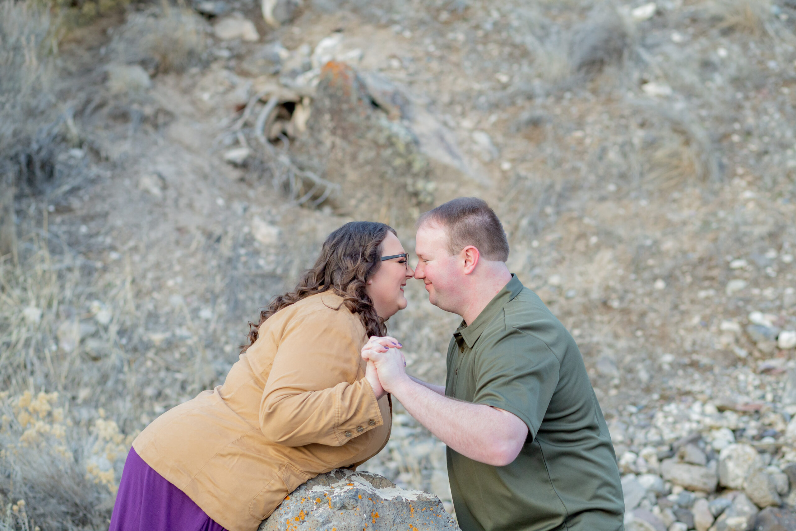 couple-kissing-over-rock-engagement-session