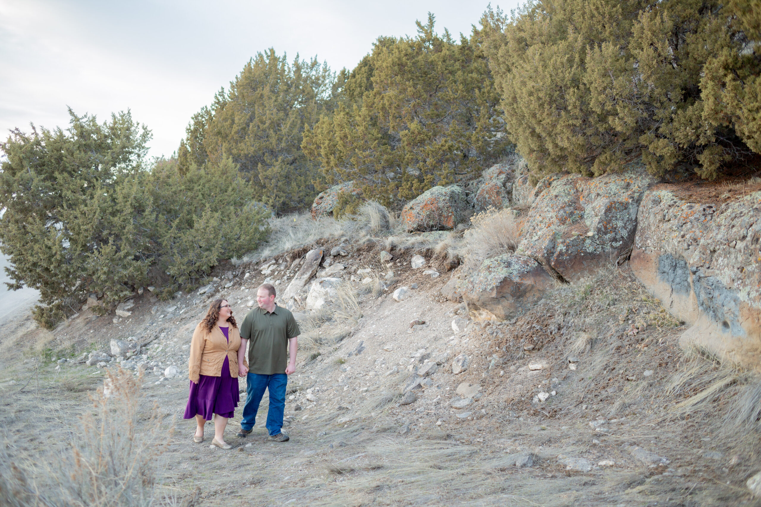 engaged-couple-walking-by-a-rocky-mountain